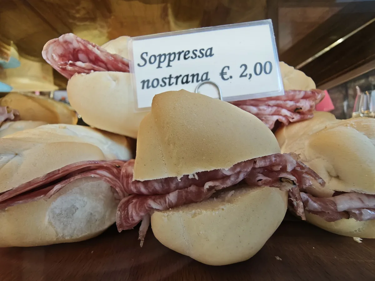 Cicchetto with local Veneto soppressa salami, 2 euro, at the Al Mercà bacaro near the Rialto market in Venice