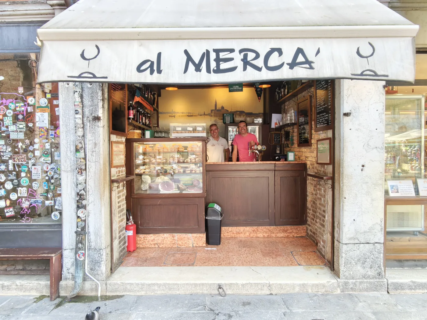 The facade of the Al Mercà bacaro with its counter and cicchetti display case, at Rialto in Venice